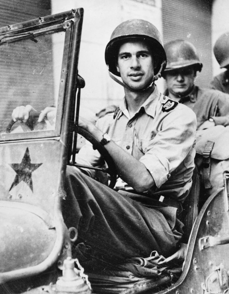 American author and Time magazine war correspondent John Hersey is shown driving a U.S. Army jeep at an unknown location during World War II, in 1944. His Pulitzer-Prize winning novel "A Bell for Adano" is a report on the Allied invasion in Italy. (AP Photo)